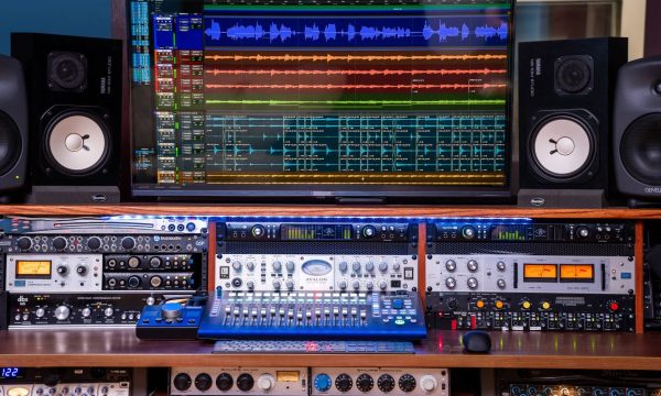 Straight-on shot of rack section with Avalon 737 preamp, Universal Audio compressor, and screen above.