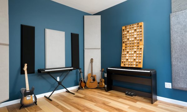A spacious view of Room C with wood paneling and upright piano, designed for both private lessons and recording flexibility.