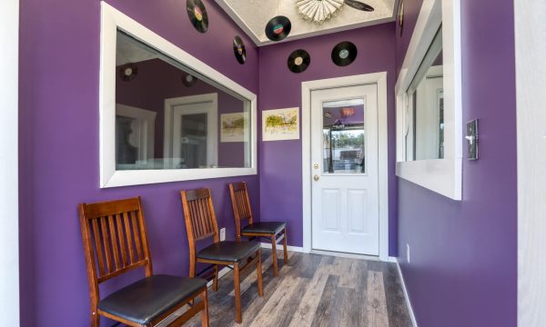 Angled view of waiting area with modern chairs and framed studio artwork.